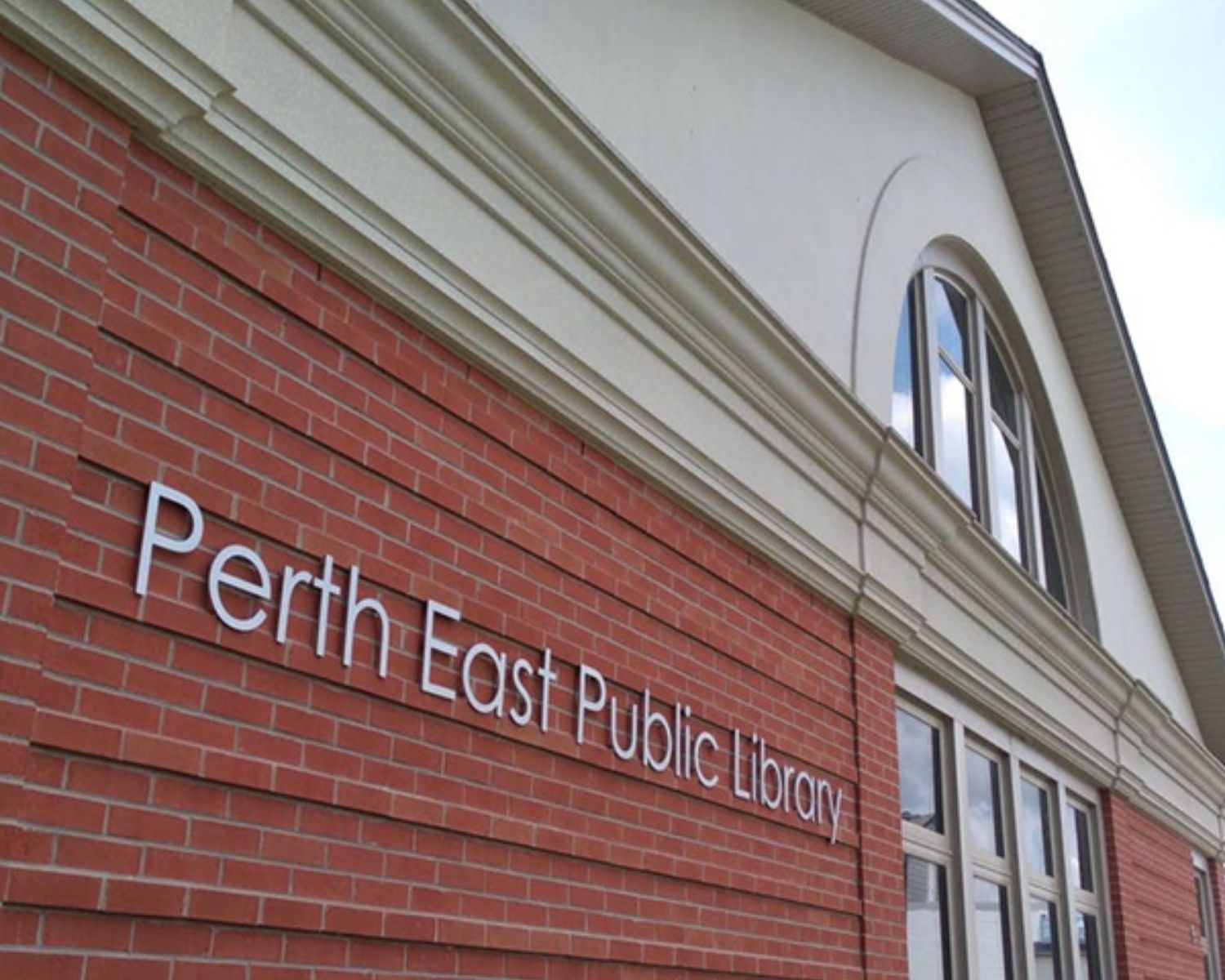 Image of the exterior PEPL building: a red brick building with the words "Perth East Public Library" 
