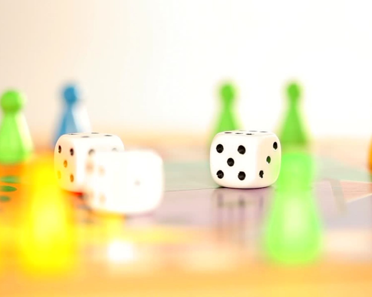 A board game with three dice and game board pieces on top
