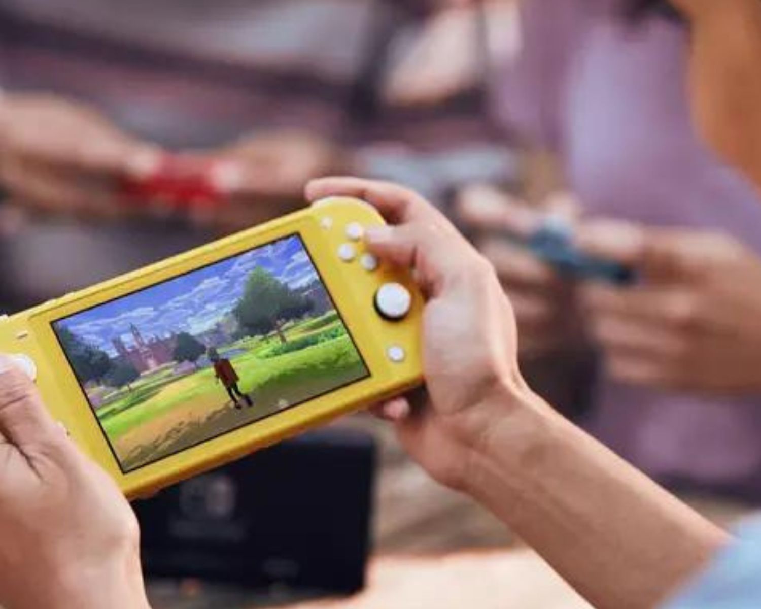 A person's hands holding a yellow Nintendo Switch